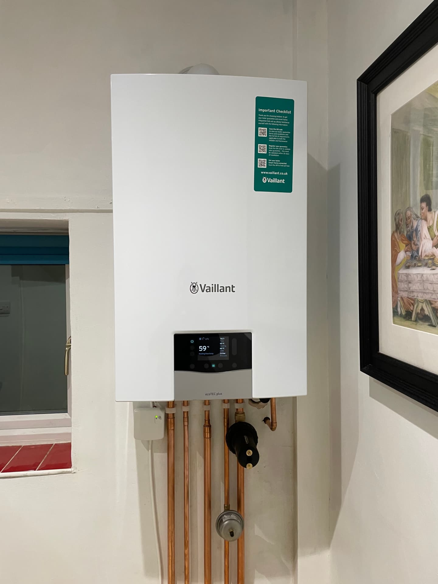 Vaillant ecoTEC plus boiler with copper pipework in a hallway