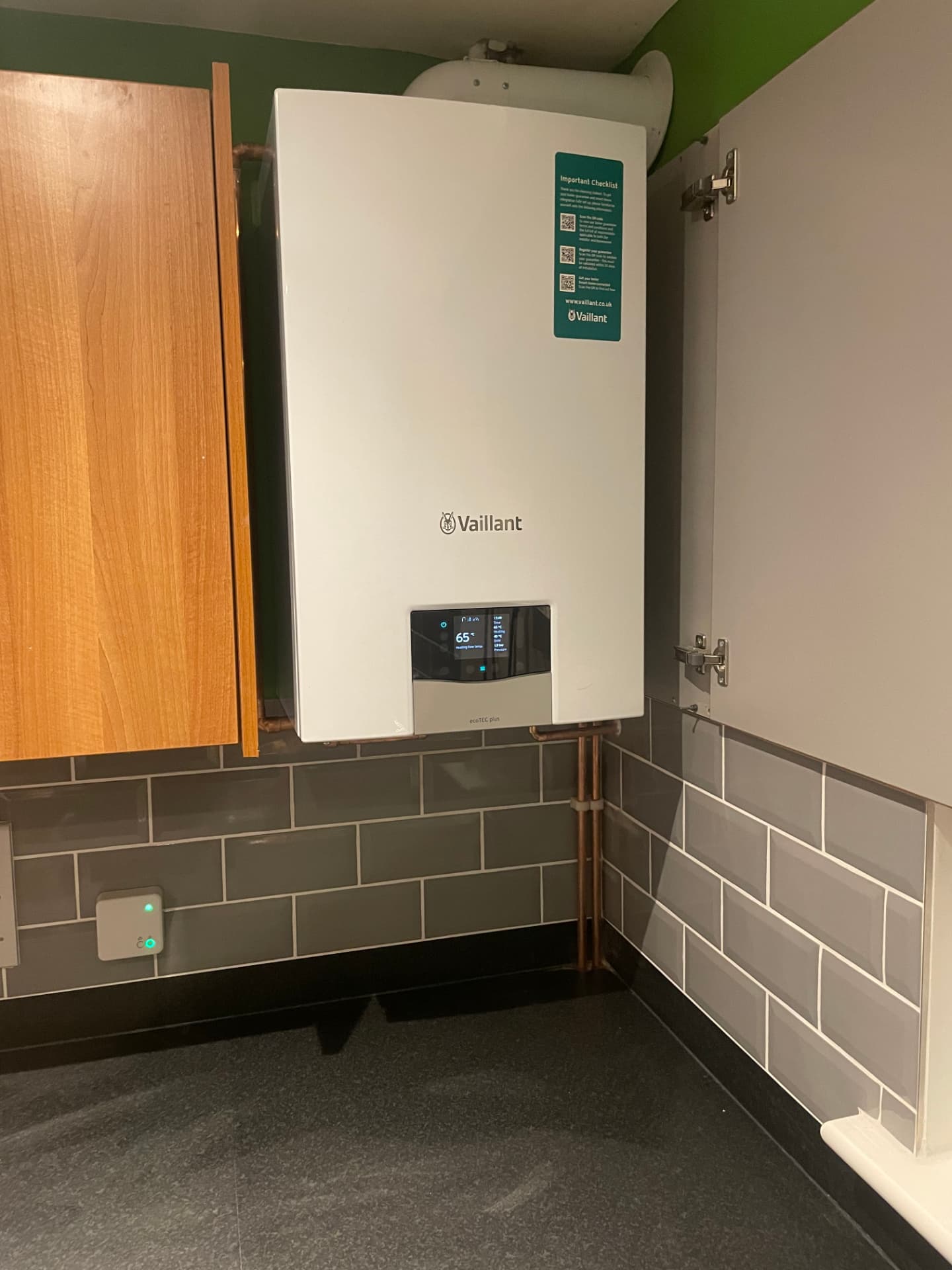 Vaillant ecoTEC plus boiler fitted inside a kitchen cupboard